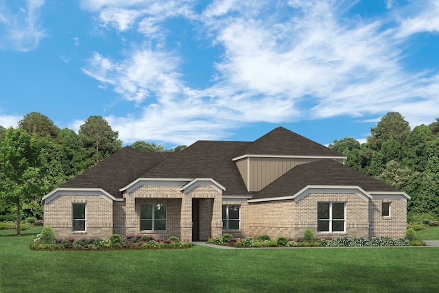 view of front facade featuring a front lawn, roof with shingles, and brick siding