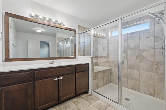 bathroom featuring vanity and a stall shower