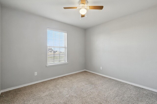 spare room with baseboards and ceiling fan