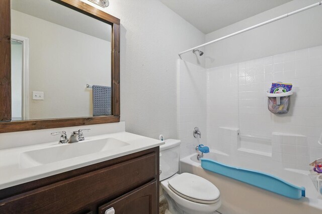 bathroom featuring toilet, vanity, and shower / bathing tub combination