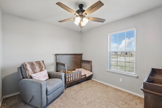 carpeted bedroom with a ceiling fan and baseboards