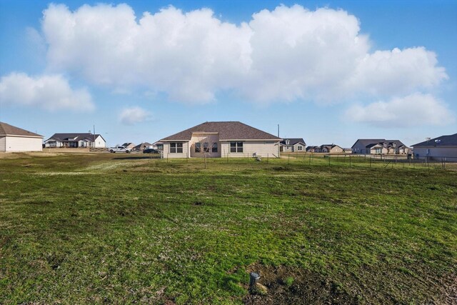 view of yard featuring a residential view and fence