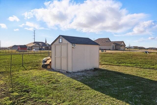 view of shed featuring fence