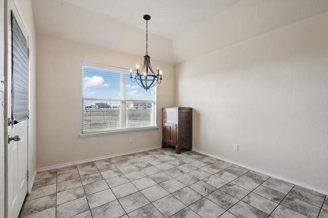 unfurnished dining area with a chandelier and baseboards