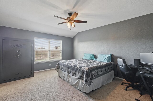 bedroom with lofted ceiling, a ceiling fan, carpet flooring, baseboards, and a textured wall