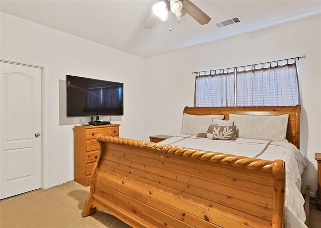 bedroom with a ceiling fan, light colored carpet, and visible vents