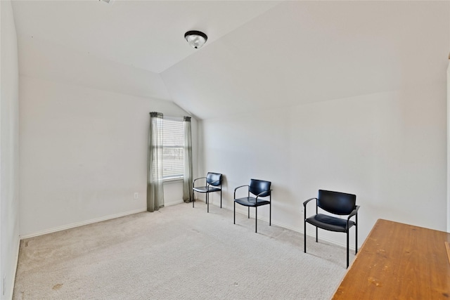 living area featuring carpet floors, baseboards, and lofted ceiling