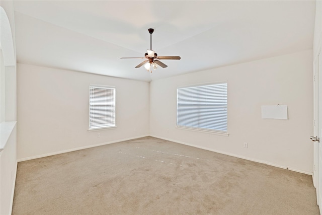 empty room with carpet, ceiling fan, and baseboards