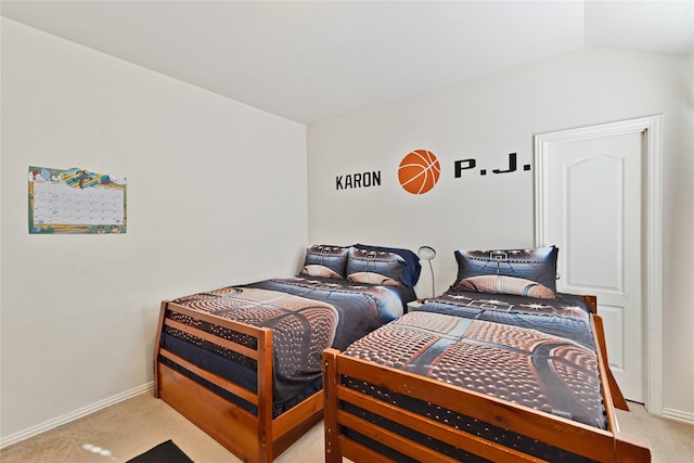 bedroom with lofted ceiling, baseboards, and light colored carpet