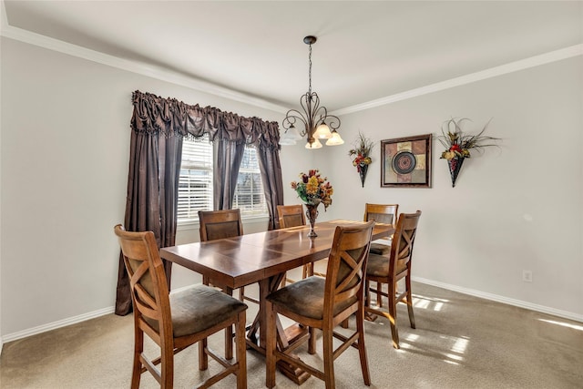 dining space featuring crown molding, a chandelier, carpet flooring, and baseboards