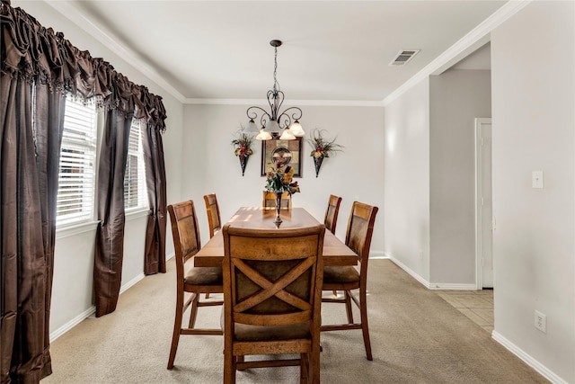 dining space featuring crown molding, a chandelier, visible vents, and light colored carpet