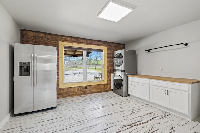 230 Frosty Hollow Rd, Denison, TX 75021 - laundry area with estacked washer and dryer, wood walls, and light wood finished floors
