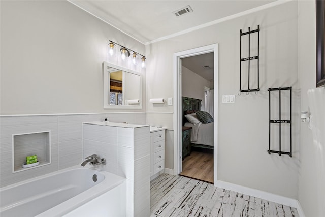 230 Frosty Hollow Rd, Denison, TX 75021 - ensuite bathroom featuring a garden tub, vanity, crown molding, wood finished floors, and baseboards