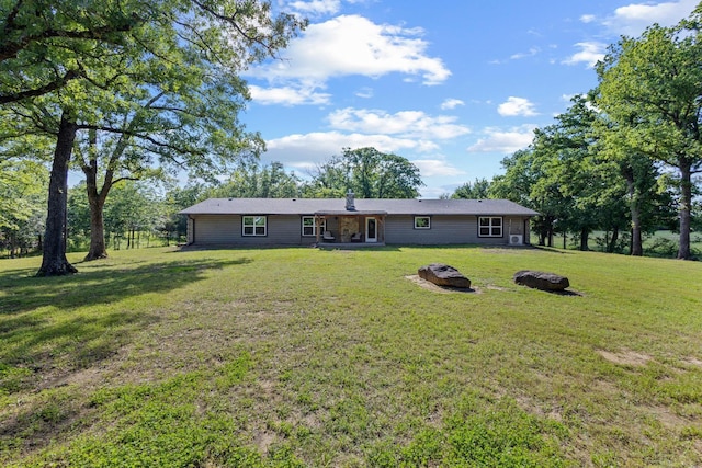 230 Frosty Hollow Rd, Denison, TX 75021 - rear view of property featuring an outdoor fire pit and a lawn