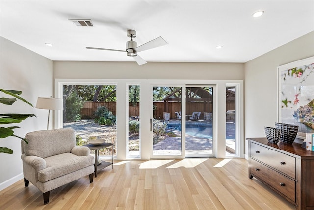 sitting room featuring light wood-style flooring, visible vents, baseboards, and recessed lighting