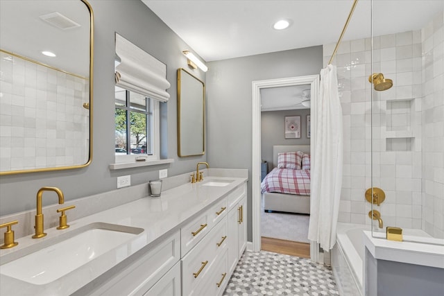 full bathroom with double vanity, a sink, shower / bath combo with shower curtain, and recessed lighting