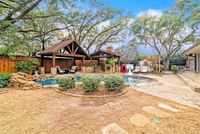 view of pool featuring a gazebo, a patio, fence, and a fenced in pool