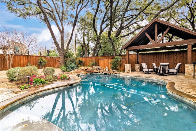 view of swimming pool featuring a gazebo, a patio, a fenced backyard, and a fenced in pool