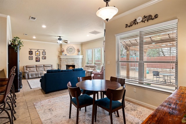 dining space featuring visible vents, ornamental molding, and light tile patterned flooring