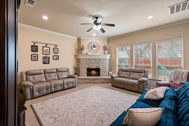 living area featuring light tile patterned floors, a fireplace, visible vents, and ornamental molding