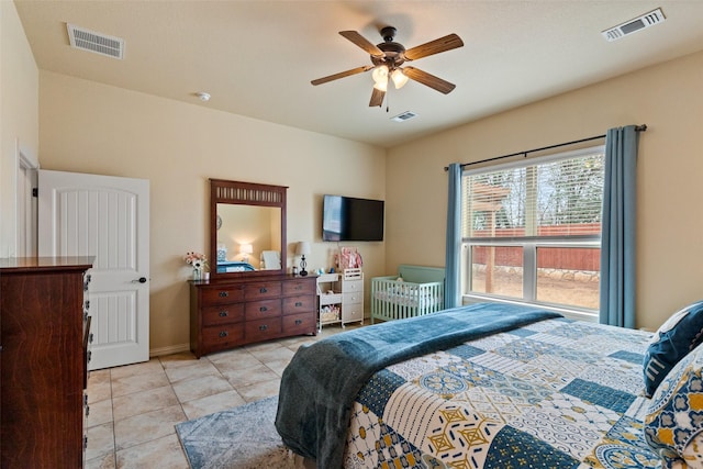 bedroom with light tile patterned floors, visible vents, and a ceiling fan