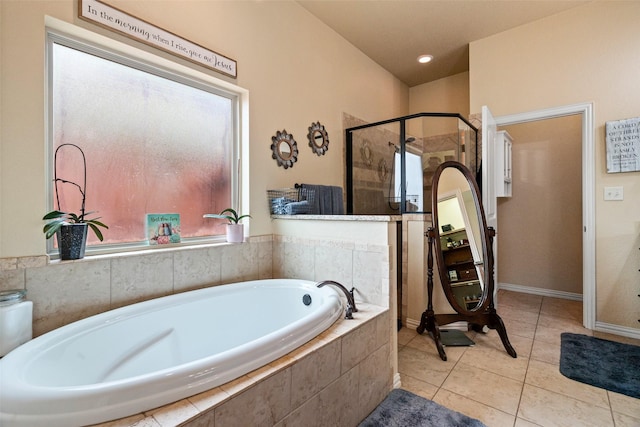 bathroom with a stall shower, a bath, and tile patterned floors