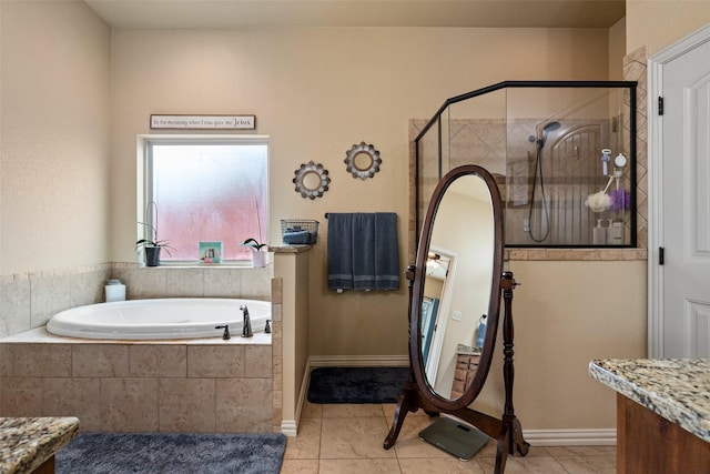 bathroom featuring a stall shower, tile patterned floors, a garden tub, and vanity