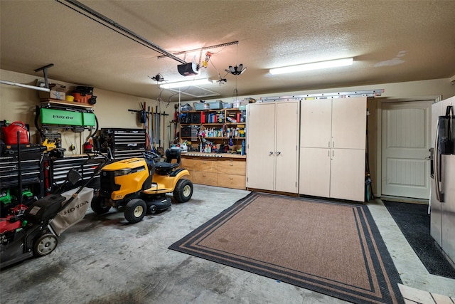 garage featuring stainless steel fridge with ice dispenser and a garage door opener