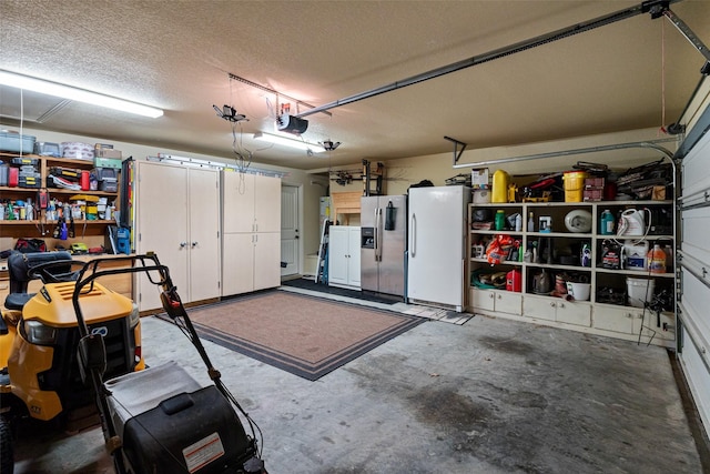 garage with a garage door opener, freestanding refrigerator, and stainless steel fridge with ice dispenser