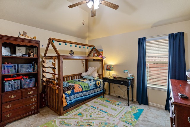 bedroom featuring lofted ceiling, multiple windows, a ceiling fan, and baseboards