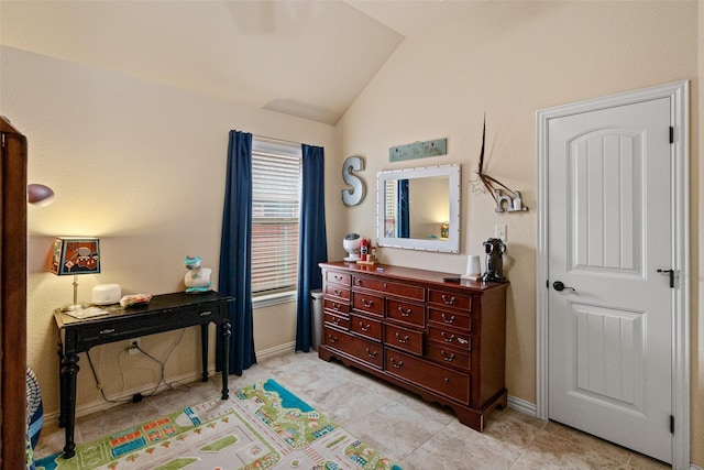 bedroom featuring vaulted ceiling and baseboards