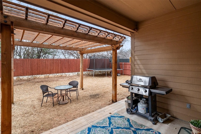 view of patio featuring a fenced backyard, a trampoline, a grill, and a pergola