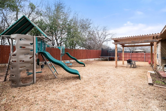 view of play area featuring a trampoline and a fenced backyard