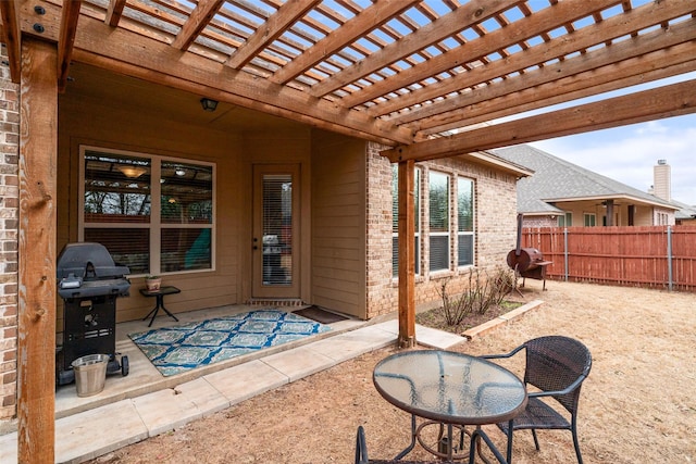 view of patio featuring grilling area, fence, and a pergola