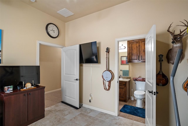 interior space featuring toilet, baseboards, visible vents, and vanity