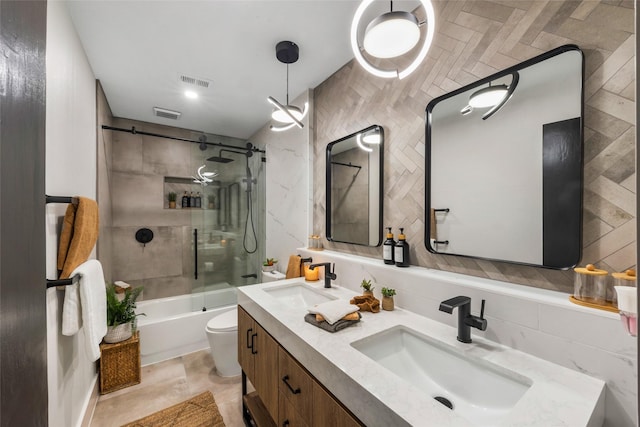 bathroom featuring visible vents, toilet, shower / bath combination, and a sink