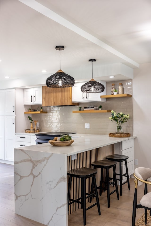 bar with hanging light fixtures, decorative backsplash, light wood-style flooring, and recessed lighting