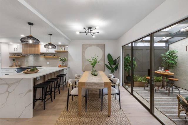 dining room featuring light wood-style floors and a chandelier