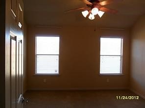 unfurnished room with ceiling fan and a wealth of natural light