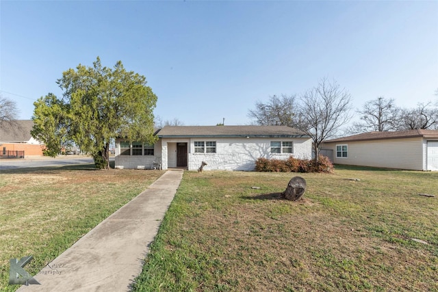 view of front of property featuring a front lawn and stone siding