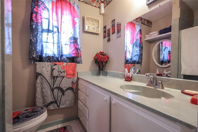 bathroom with vanity, toilet, and tile patterned floors