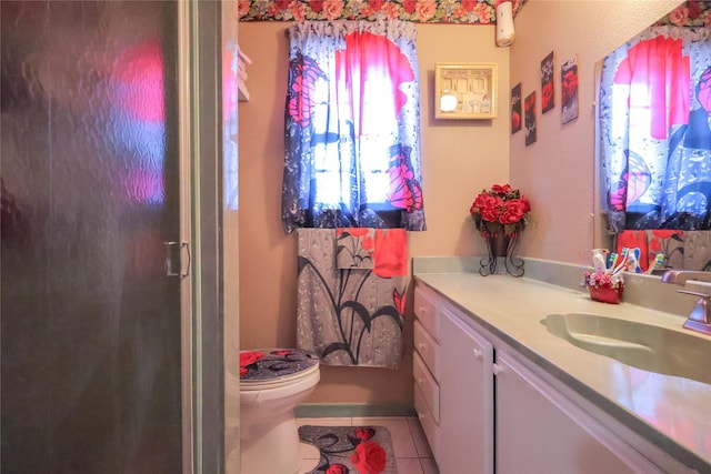 full bathroom with an enclosed shower, vanity, toilet, and tile patterned floors