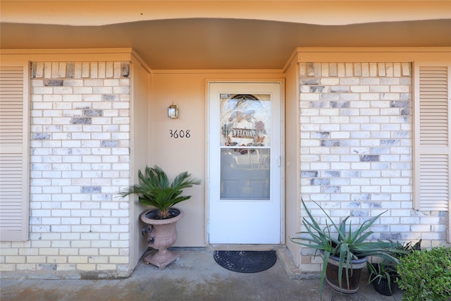 property entrance with brick siding