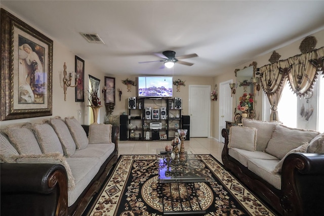 living room featuring a ceiling fan, visible vents, and light tile patterned flooring