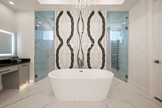 full bath with a marble finish shower, marble finish floor, vanity, and a freestanding tub