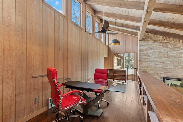 unfurnished office with beam ceiling, wood-type flooring, wooden walls, high vaulted ceiling, and wooden ceiling