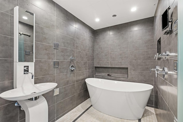 full bath with recessed lighting, a freestanding tub, and tile walls