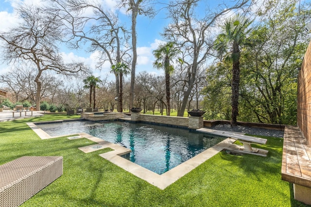 outdoor pool featuring a patio area, a yard, and an in ground hot tub