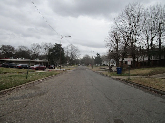 view of road with street lighting and curbs