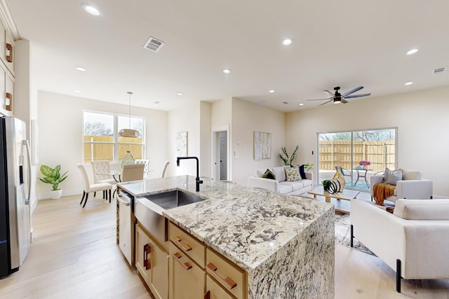 kitchen with recessed lighting, stainless steel appliances, a sink, and open floor plan